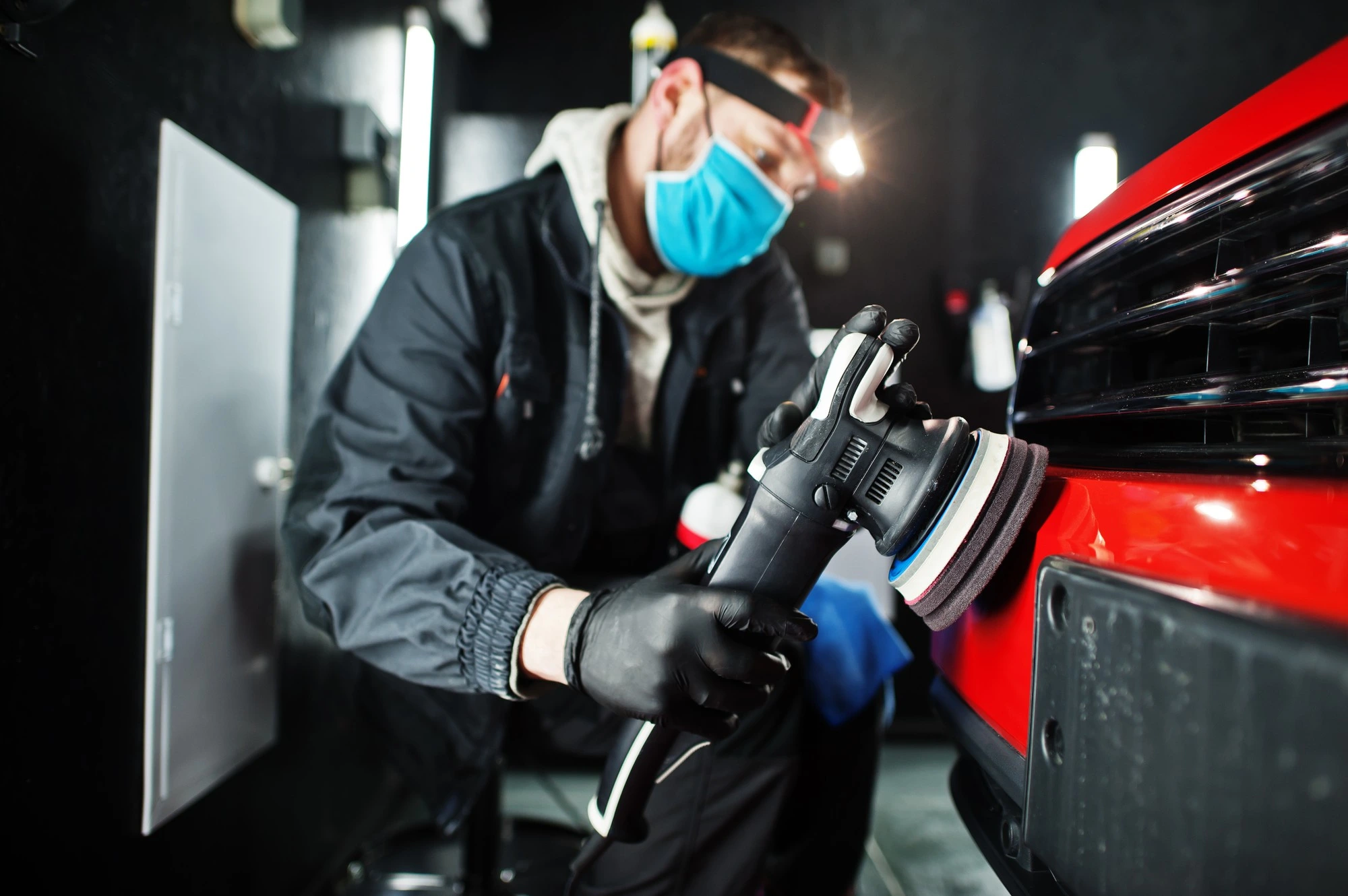 Automotive mechanic working on car engine
